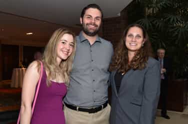 2 women & 1 man posing