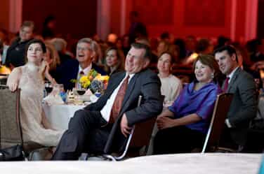 Michael Rawlings seated at table and smiling